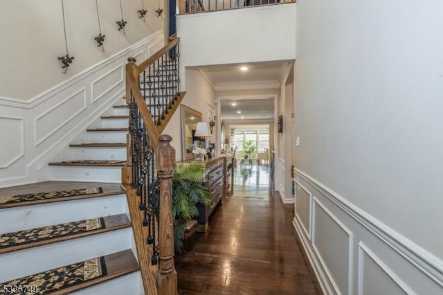 staircase featuring hardwood / wood-style flooring and ornamental molding