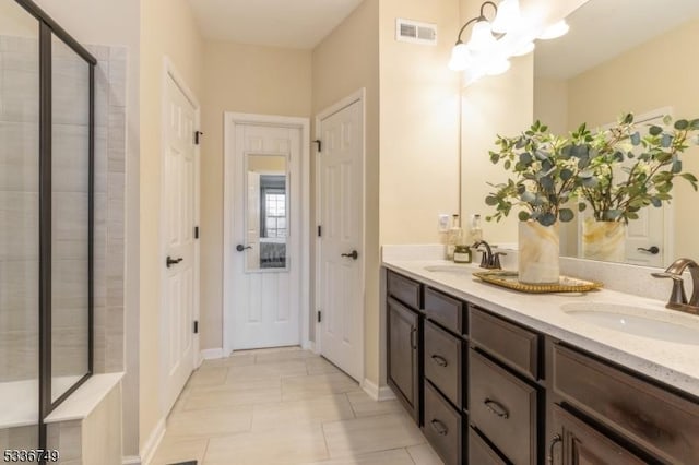 bathroom featuring an inviting chandelier, tile patterned floors, vanity, and an enclosed shower