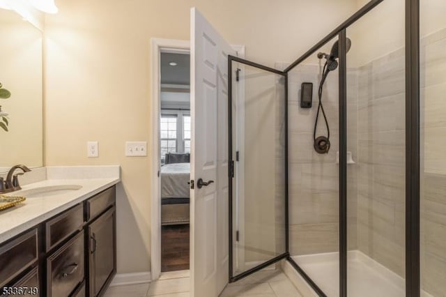 bathroom with vanity, tile patterned floors, and a shower with door