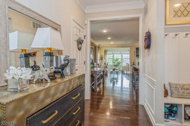 corridor featuring crown molding and dark wood-type flooring