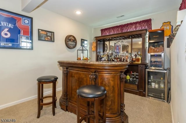 bar featuring beverage cooler and light carpet