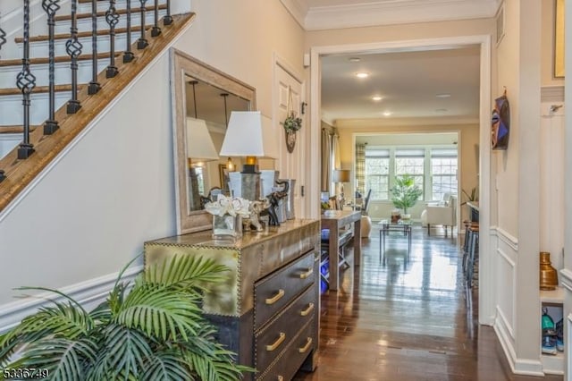 hall with ornamental molding and dark hardwood / wood-style floors