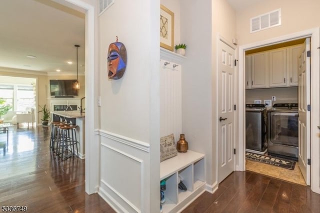 mudroom featuring washing machine and dryer and dark hardwood / wood-style floors