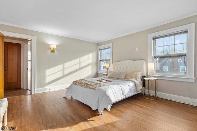 bedroom with crown molding and light hardwood / wood-style floors