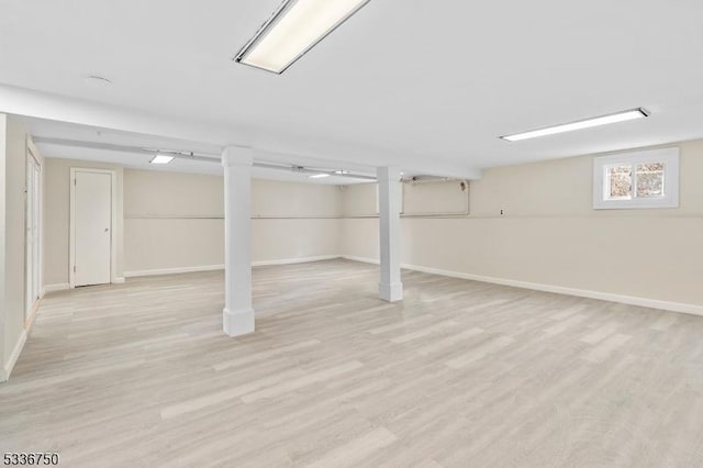 basement with light hardwood / wood-style floors