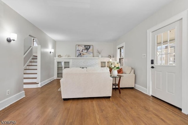 living room featuring hardwood / wood-style floors and a brick fireplace