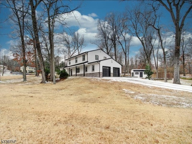 exterior space featuring a garage and a front lawn