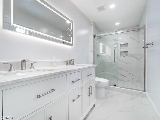 bathroom with vanity, a shower with door, and toilet