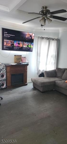 living room with ceiling fan, wood-type flooring, and beam ceiling