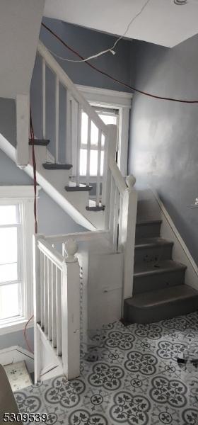 stairway with tile patterned floors