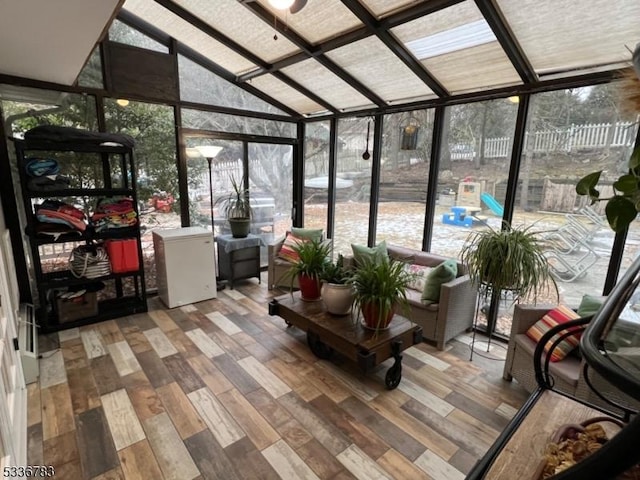 sunroom / solarium featuring lofted ceiling