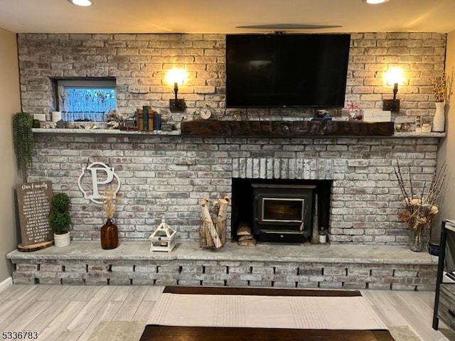 interior space with hardwood / wood-style flooring and a wood stove