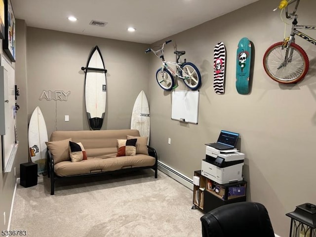 sitting room with a baseboard radiator and light colored carpet