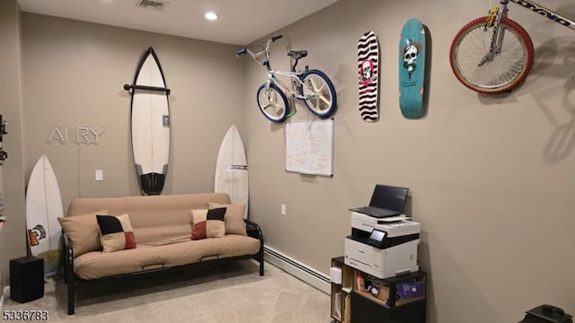 sitting room featuring baseboard heating and light colored carpet