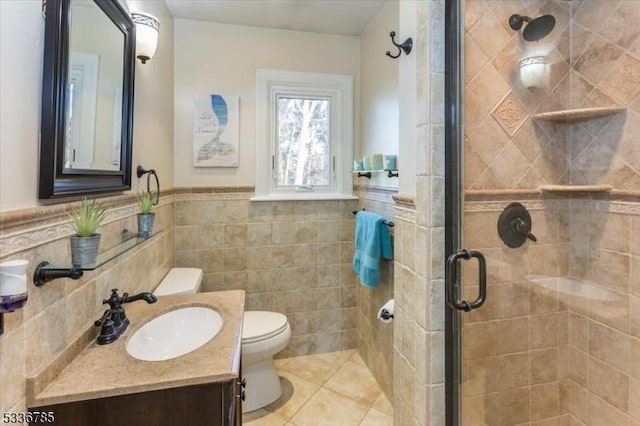 bathroom featuring tile walls, vanity, an enclosed shower, tile patterned floors, and toilet