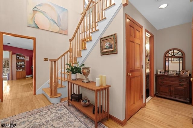 foyer entrance with light hardwood / wood-style floors