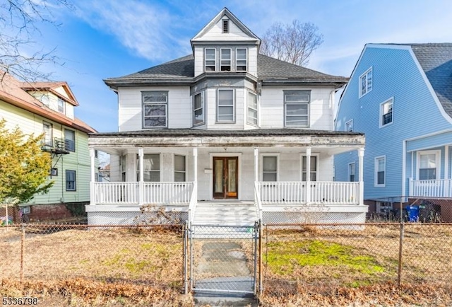 victorian house featuring a porch and a front yard