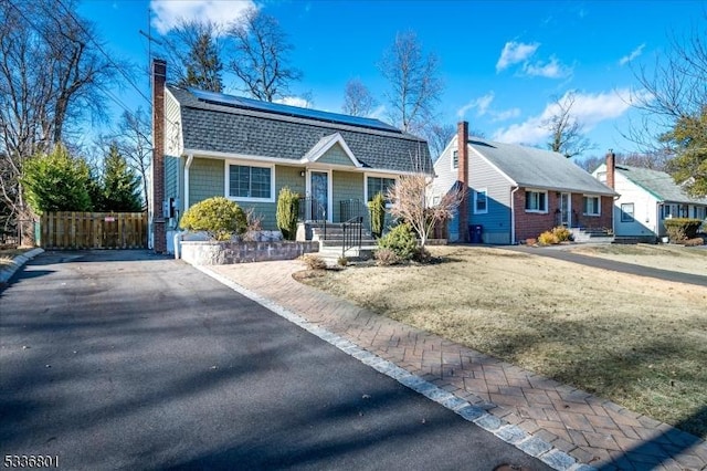 bungalow-style house featuring a front yard