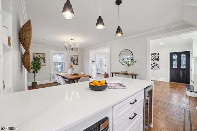 kitchen with white cabinetry, pendant lighting, dark parquet floors, and beverage cooler