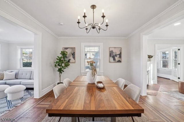 dining area with ornamental molding and an inviting chandelier