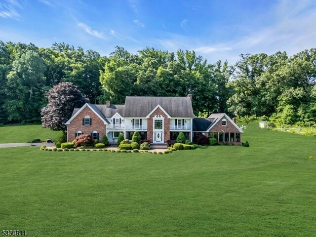 view of front of house with a chimney and a front yard