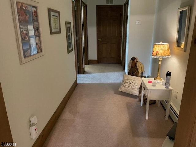corridor with carpet floors, baseboards, visible vents, and a baseboard radiator