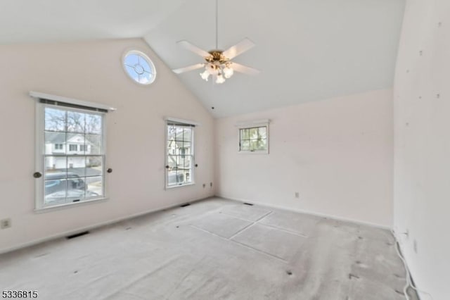 carpeted spare room featuring high vaulted ceiling and ceiling fan