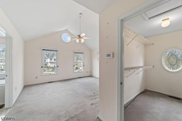 interior space with lofted ceiling, light carpet, and ceiling fan