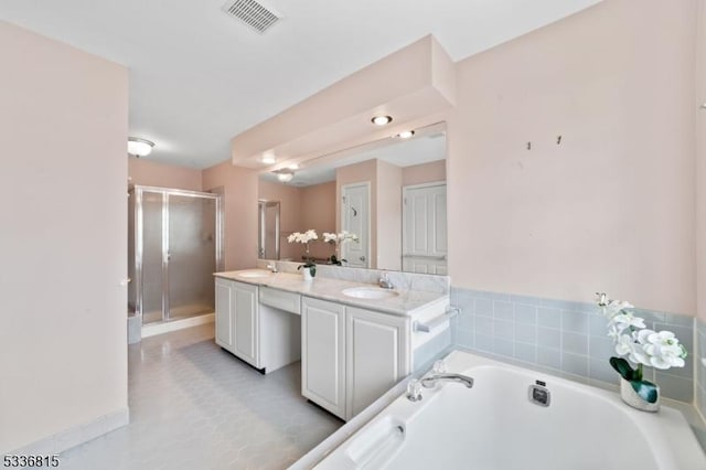 bathroom with independent shower and bath and vanity