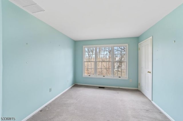 spare room with light colored carpet