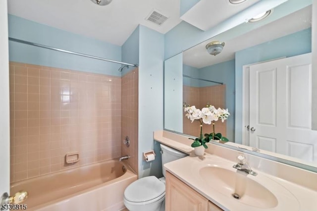 full bathroom featuring vanity, toilet, and tiled shower / bath