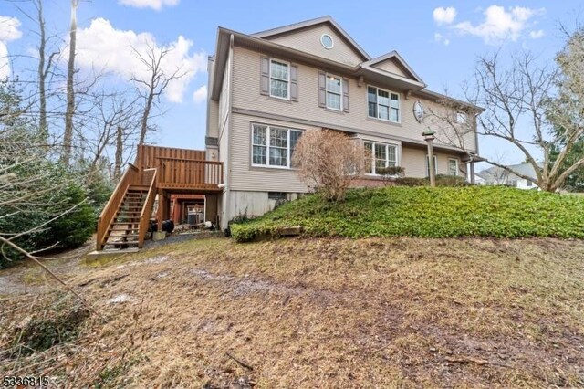 rear view of property featuring a wooden deck