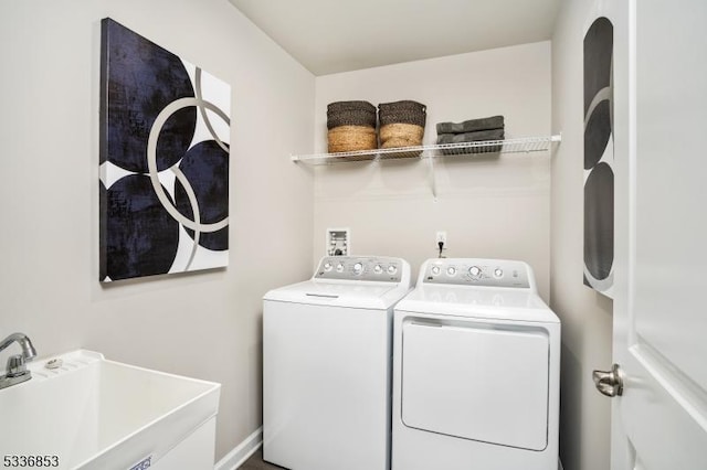 washroom with sink and independent washer and dryer