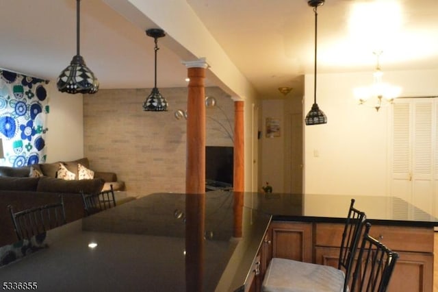 interior space featuring ornate columns and decorative light fixtures