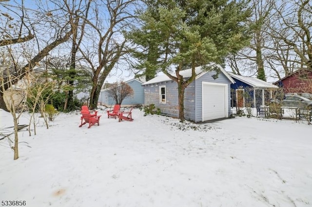 yard covered in snow with a garage