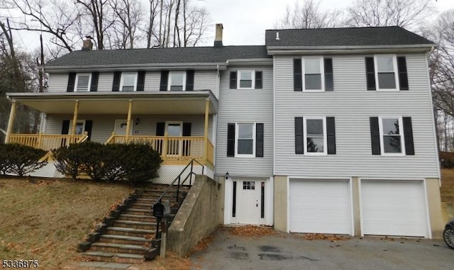 view of front facade featuring a porch and a garage