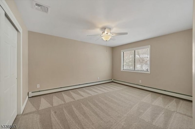 carpeted empty room featuring a baseboard radiator and ceiling fan