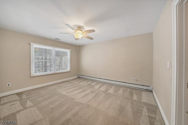 spare room with a baseboard heating unit, light colored carpet, and ceiling fan