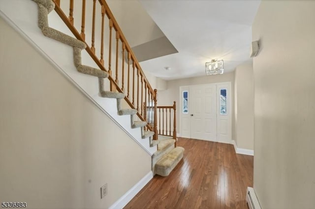 entrance foyer with hardwood / wood-style floors and baseboard heating