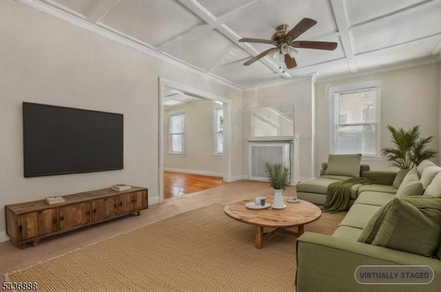 living room featuring ornamental molding, ceiling fan, and coffered ceiling