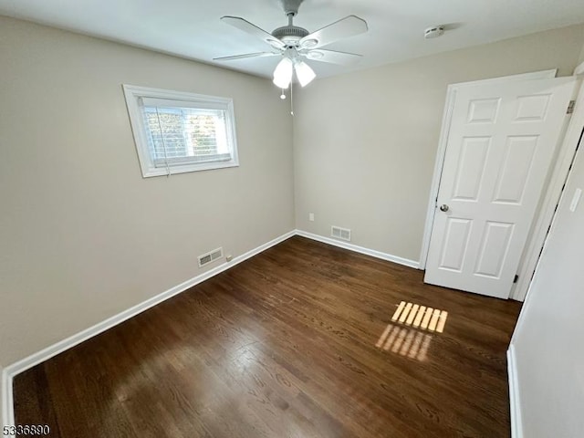 empty room featuring dark hardwood / wood-style floors and ceiling fan