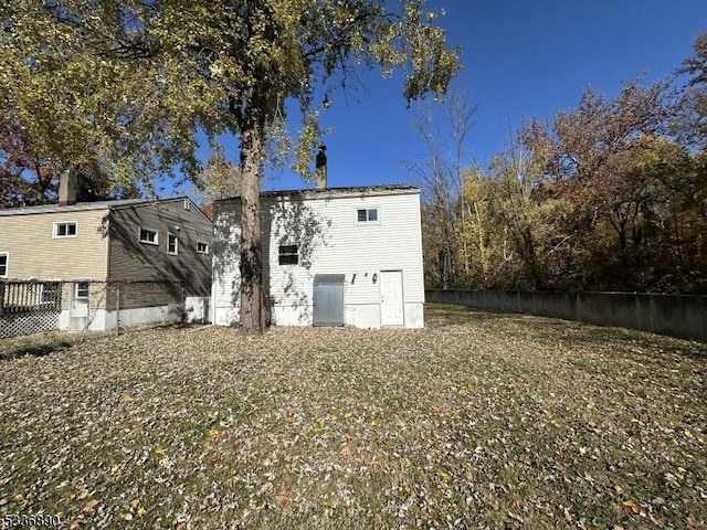 rear view of property with a yard