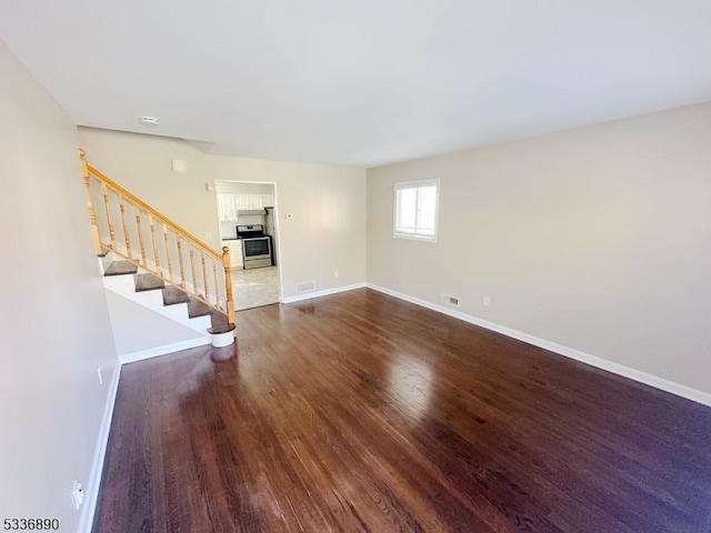 unfurnished living room with dark hardwood / wood-style floors