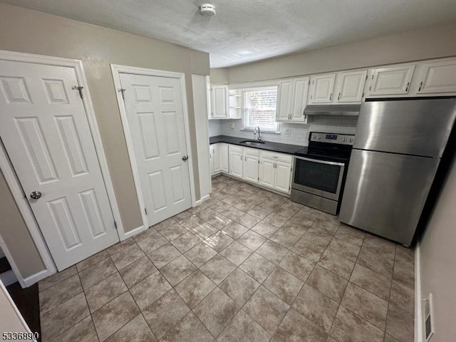 kitchen featuring white cabinetry, appliances with stainless steel finishes, sink, and decorative backsplash