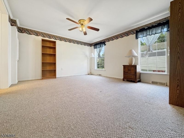 carpeted empty room with ornamental molding and ceiling fan