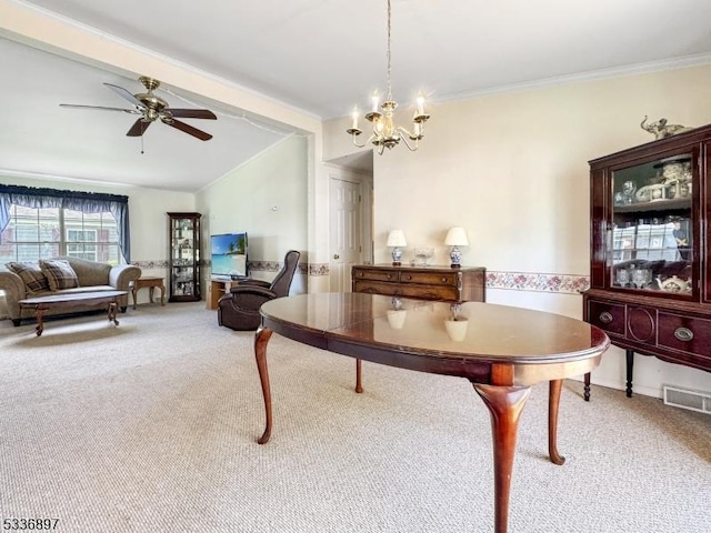 carpeted dining space with crown molding, vaulted ceiling, and ceiling fan with notable chandelier