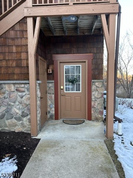 view of snow covered property entrance