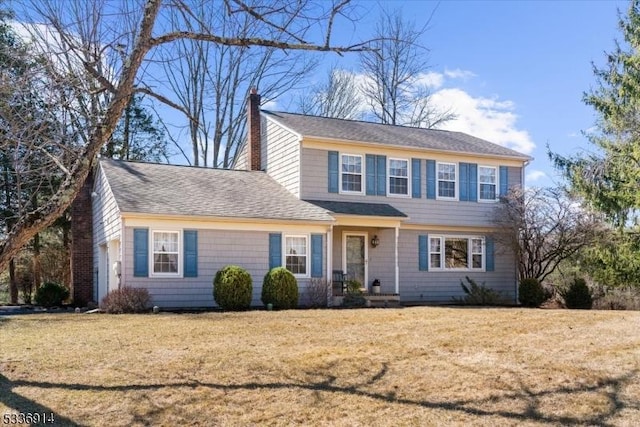 view of front of home featuring a front yard and a chimney