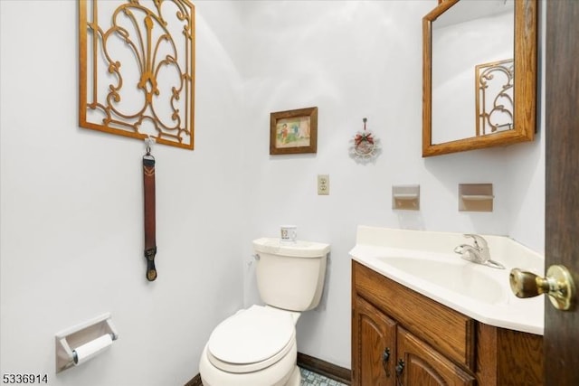 half bathroom with vanity and toilet