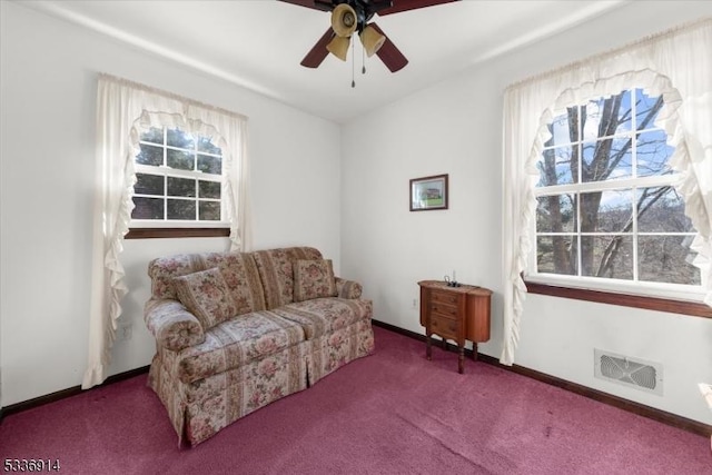 sitting room with a ceiling fan, carpet, visible vents, and baseboards